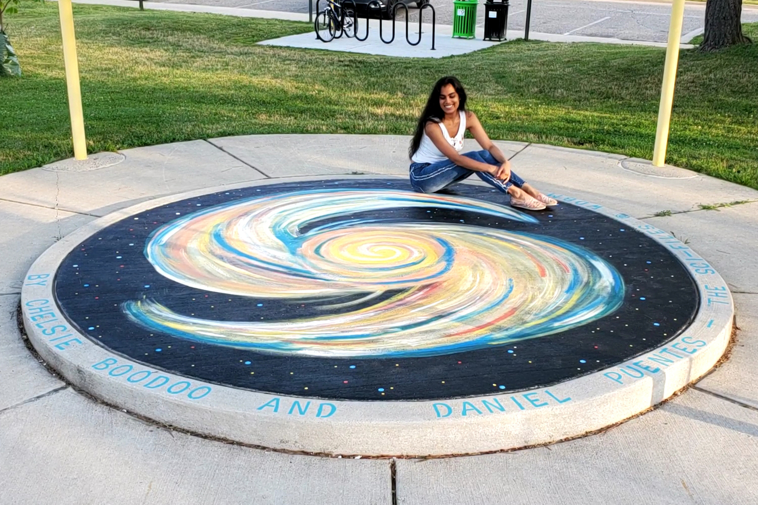 Woman posing with sidewalk chalk art