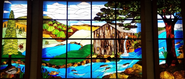A photo of Living in Harmony with Nature: the second floor stained glass mural in Farrall Hall. 