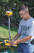 Photo of a Technology Systems Management student working with GPS data acquisition equipment 