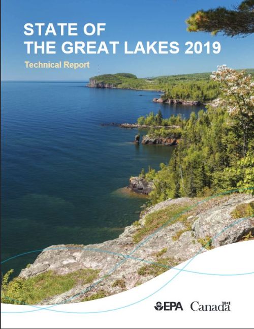 Cover of the 2019 State of the Great Lakes 2019 technical report shows a Great Lakes shoreline from above on a rocky hill so you can see along the shoreline into the distance.