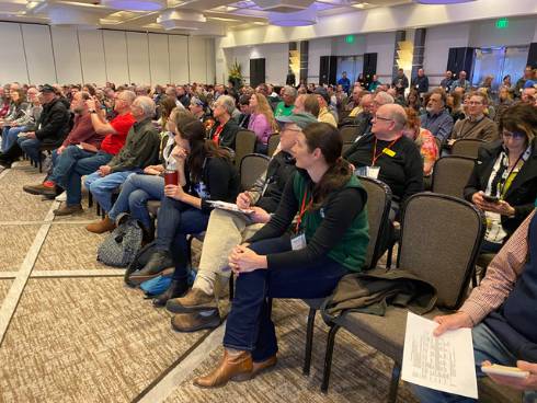 Photo of a seated audience at a beekeeping conference
