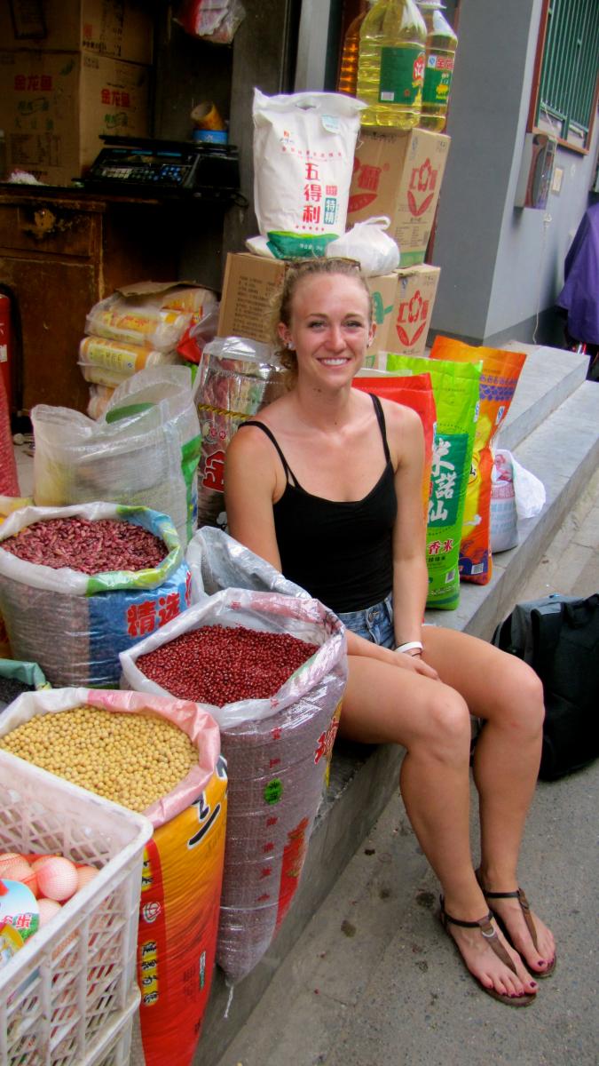 Anna Herzberger surrounded by soybeans