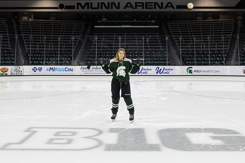 Lily Kirkman on the ice in hockey gear at Munn Ice Arena.