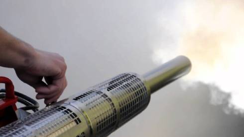 person using a greenhouse fogger