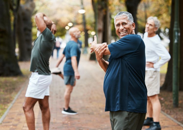 Older adults stretching outside.