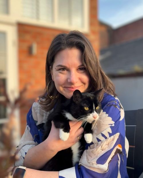 A woman holding a cat.