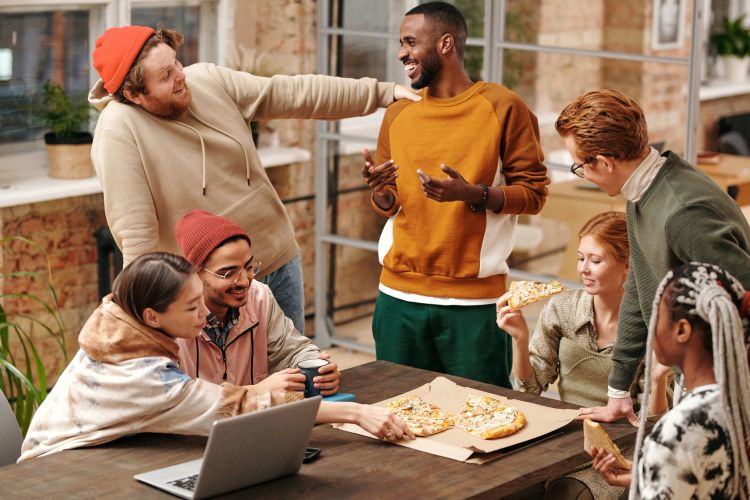 Multiracial group of people by a table.