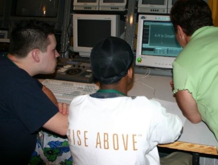 Youth sitting at a computer.