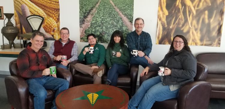 A group of people sitting down, posing for a picture