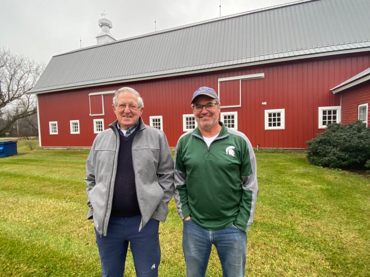 William (Bill) Oswalt and his son Mike Oswalt, also an MSU animal science alumnus on their family farm.