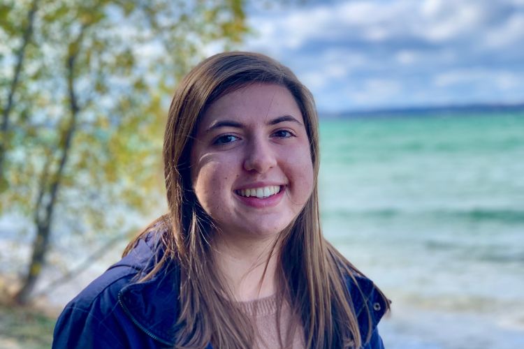 Andrea Green smiling in front of a body of water