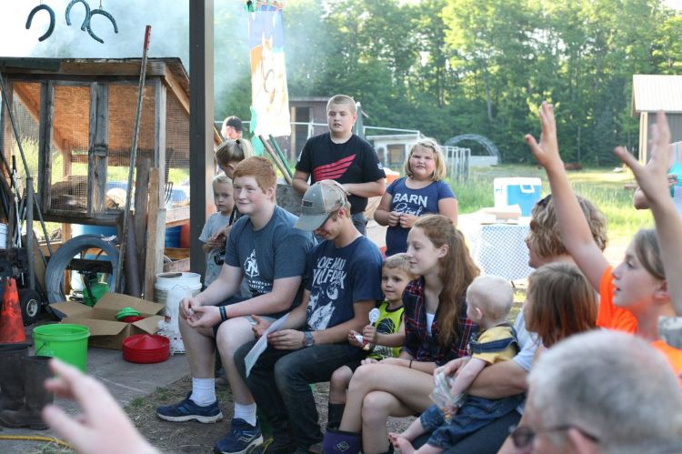 Young people and kids  at a picnic.