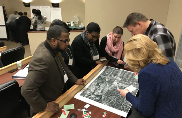 Attendees working in groups during session.