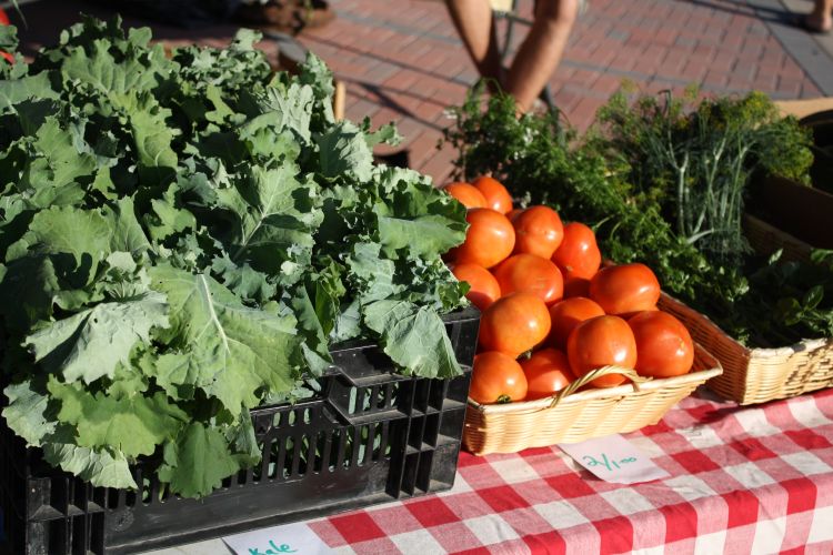 Some vegetables sitting in a container on a table.