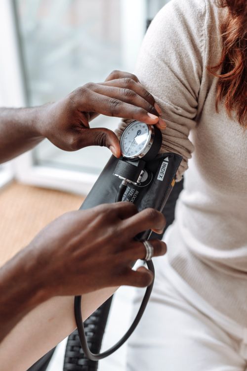 Doctor checking a patient's blood pressure.