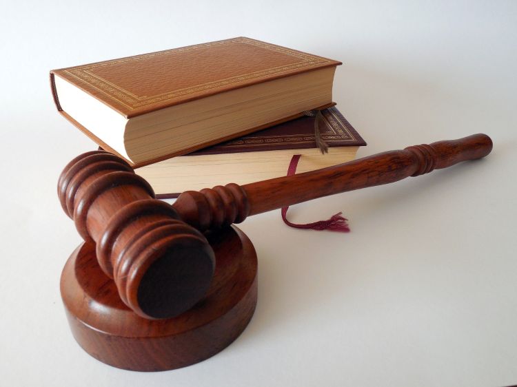 Gavel next to stack of books.