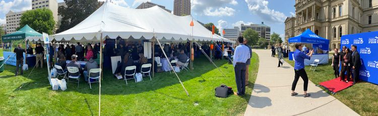 A picture the north side of the Capitol lawn looking toward the front of the Capitol. A large white tent is in the foreground of the building. The Fish Expo displays were located under the tent.