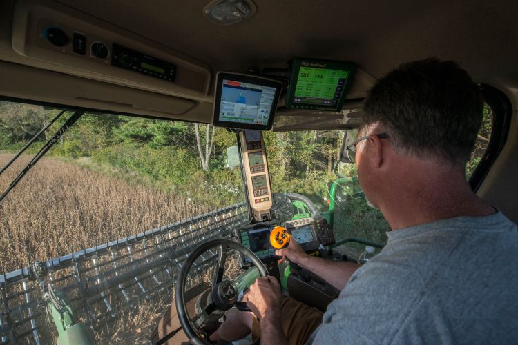 Jeff Sandborn monitors his GPS equipment while harvesting