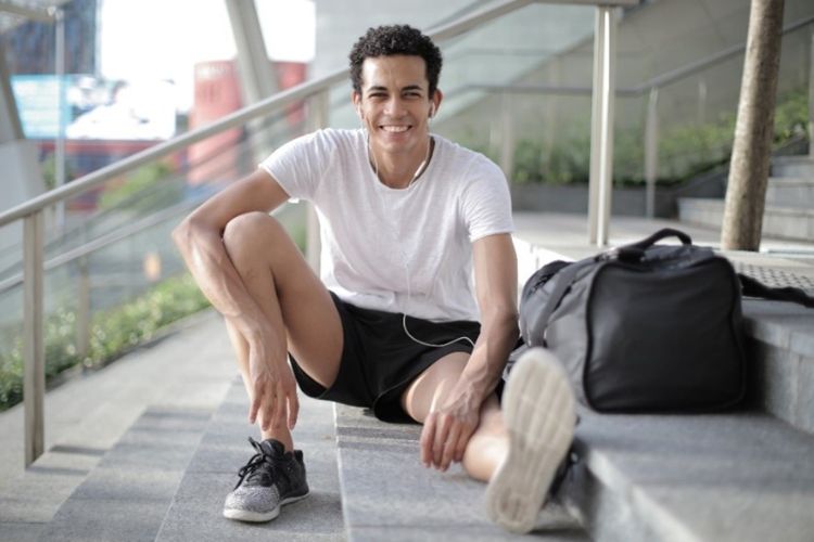 A young man smiling outside.