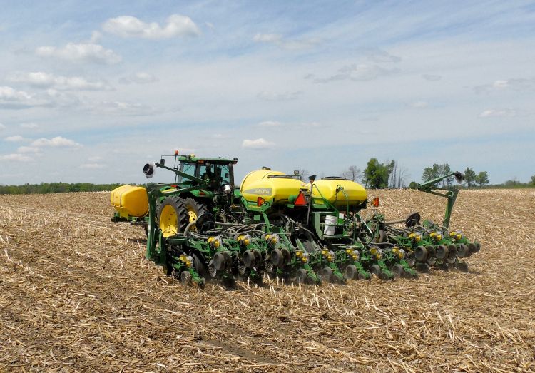 A tractor planting crops in a field