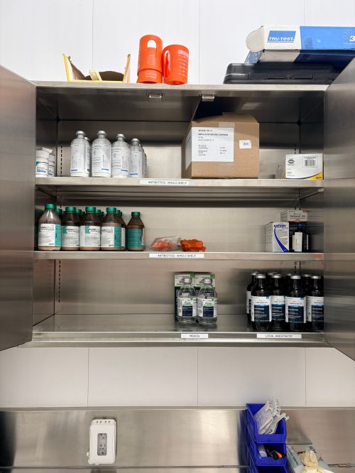 shelves with various medications used for sick dairy cattle