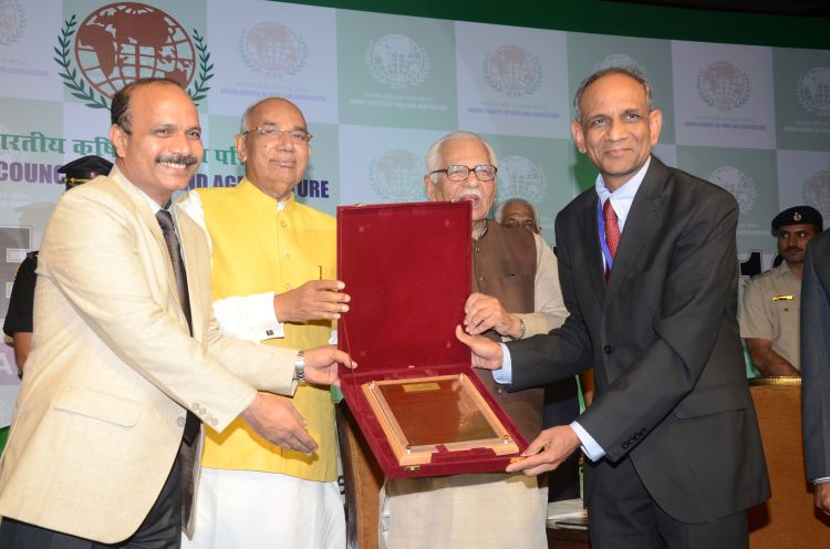 Karim Maredia (right) receives the International Leadership Award from the ICFA.