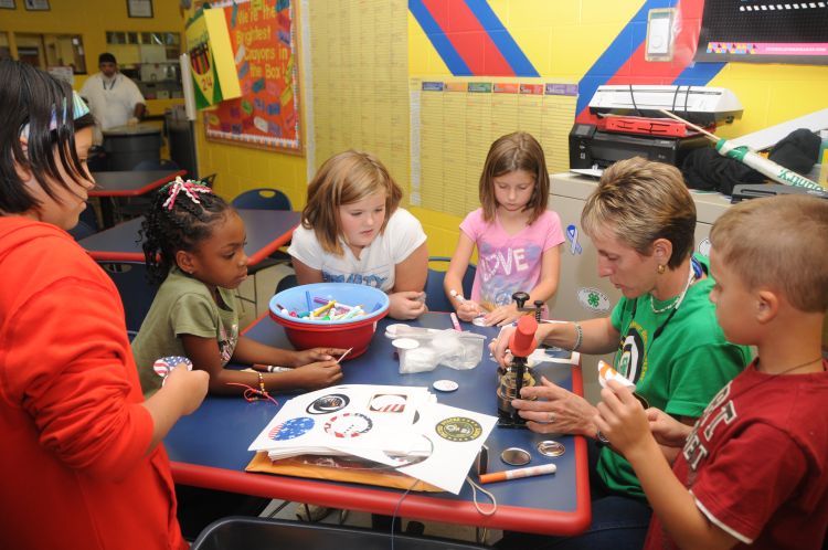 Adult and youth working on crafts at a table