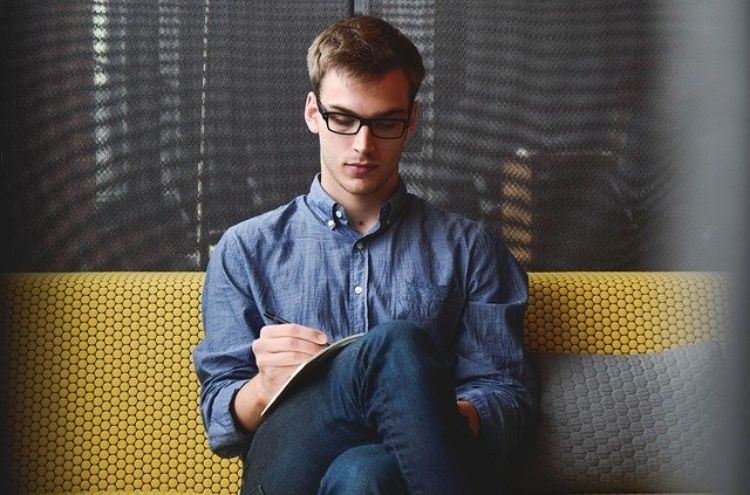 Man writing in a journal