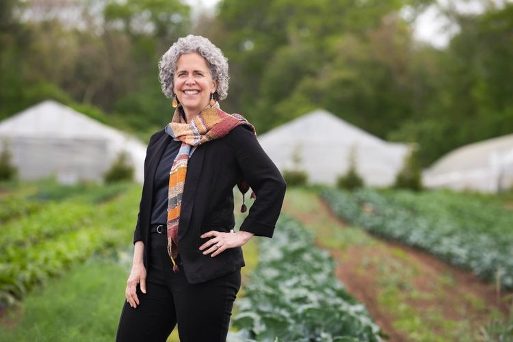 Nessa Richman stands in a farm field.