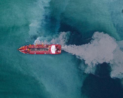 Aerial view of a hopper dredge collecting sand from the bottom of the ocean during a beach replenishment project. Credit:  Sky Cinema