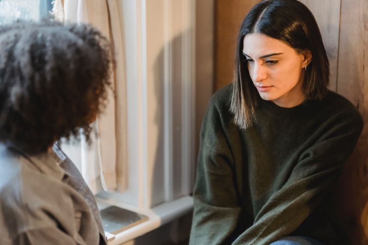 Two young women talking.