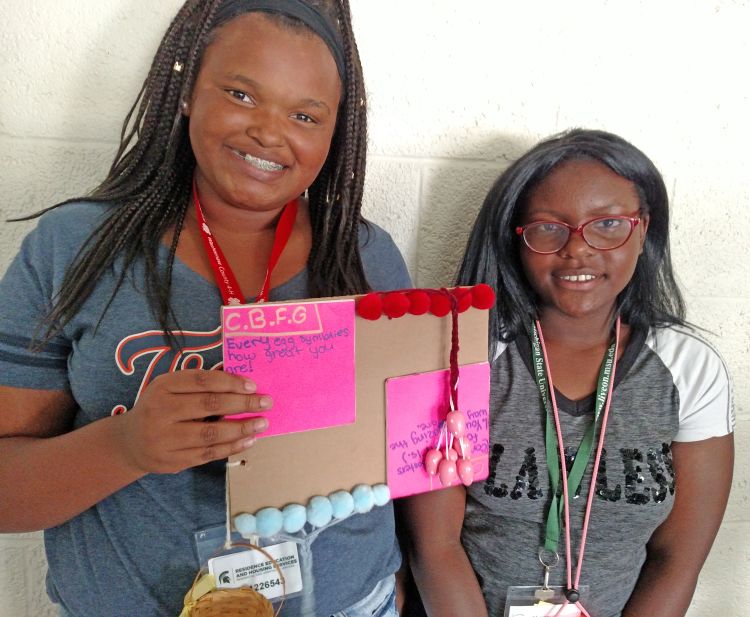 Girls holding CBFG sign