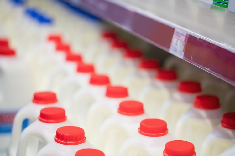 A photo of the milk section of a grocery store .