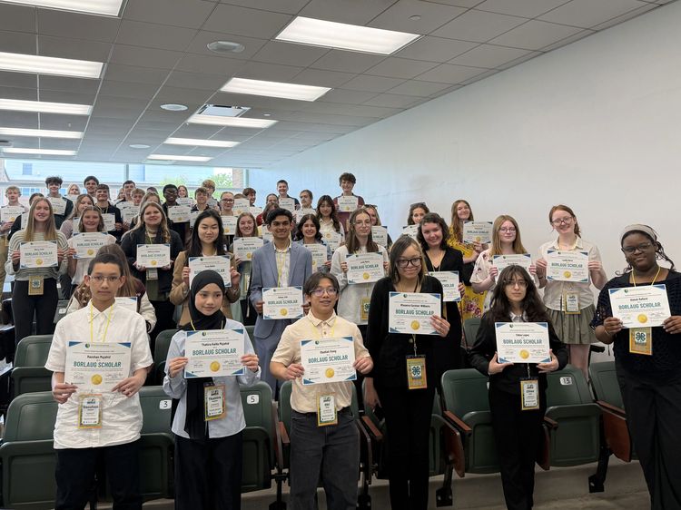 A group of youth holding up certificates.