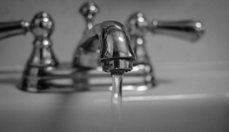 Faucet with water flowing.