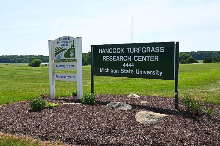 Image of a sign at the entrance of the Hancock Turfgrass Research Center at MSU.