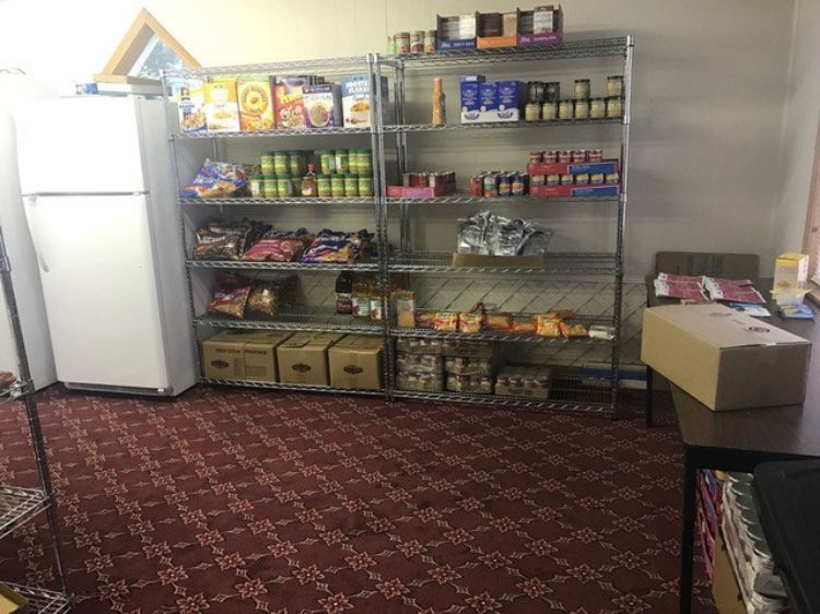 Canned food on metal shelves.