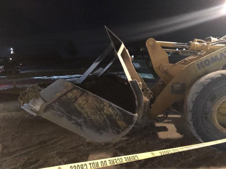 brown and yellow frunt end loader with a bucket and lights