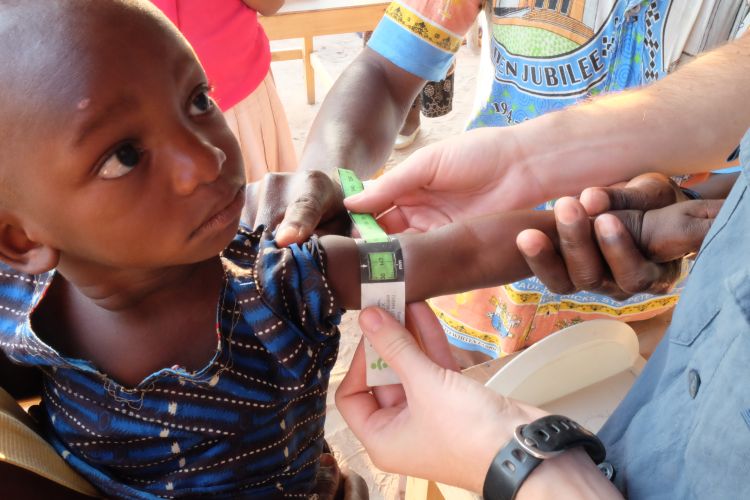 A child having their arm measured during a clinical trial in Malawi.