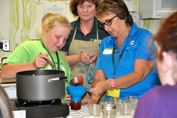 Youth learning the importance of food preservation safety.