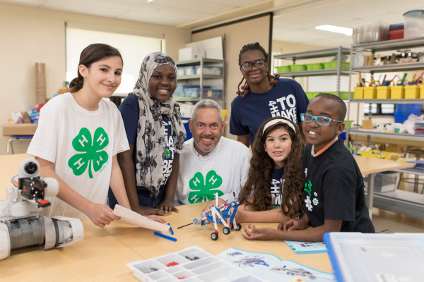 Five youth a volunteer doing a STEM project.