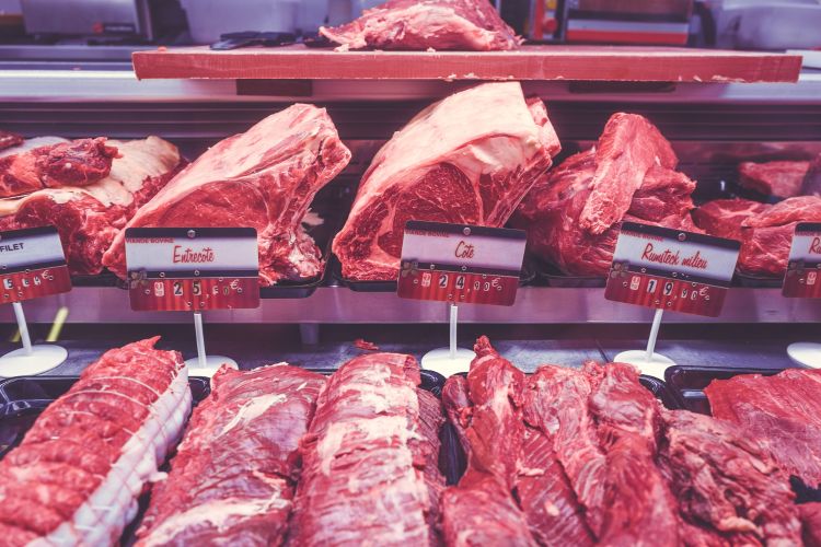 Raw meat in cooler at grocery store.