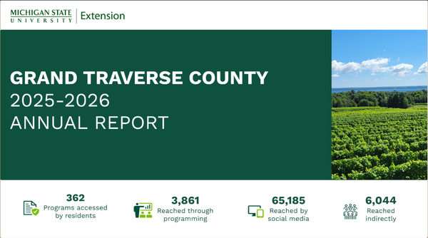 Title page of Grand Traverse County Annual Report. Green block with text, image of vineyard with blue sky and clouds.