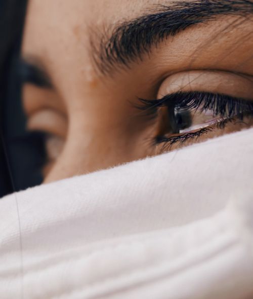 Close up of a woman's face who is crying.