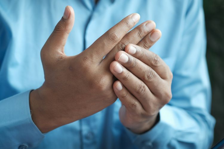 A person clutching their hands.