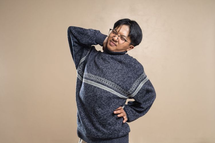 A photo of a man stretching his back.