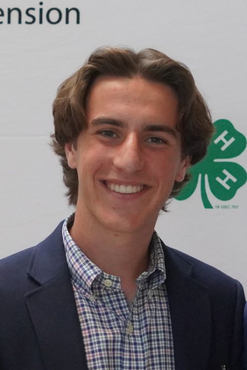 A photo of Shepherd Thompson wearing a checkered shirt and a blue blazer