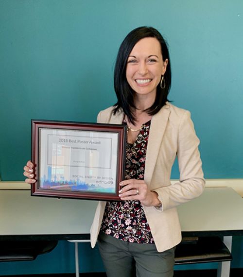 Image of Kristy Kellom holding her award.