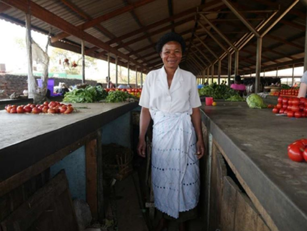 Malawian woman standing at a market.