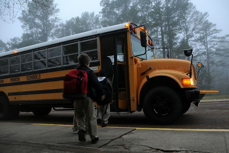 Kids getting on a school bus